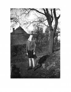 a young girl standing in a garden with a bunker behind her