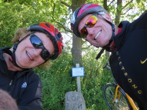 Two bicyclists at a sign marker
