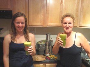 Two women with juice and juicer