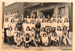 class photo in front of high school