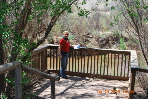 Woman standing on a deck next to the Pecos River - love historical fiction