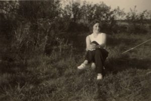 a young woman sitting in the grass