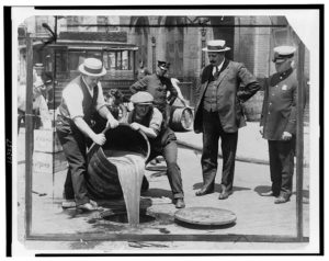 men spilling liquor into the street during prohibition