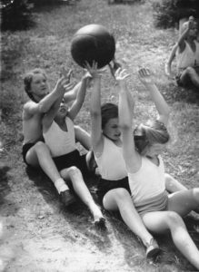 four girls playing with a ball