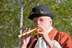 man playing with two recorders