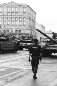 police man in front of tanks