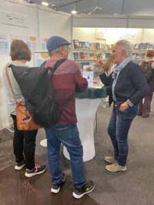 Frau am LBM Stand mit Gästen