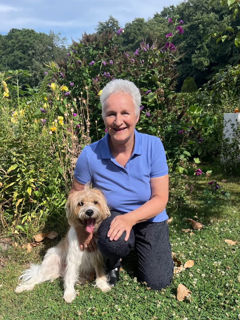 Woman with her dog in garden